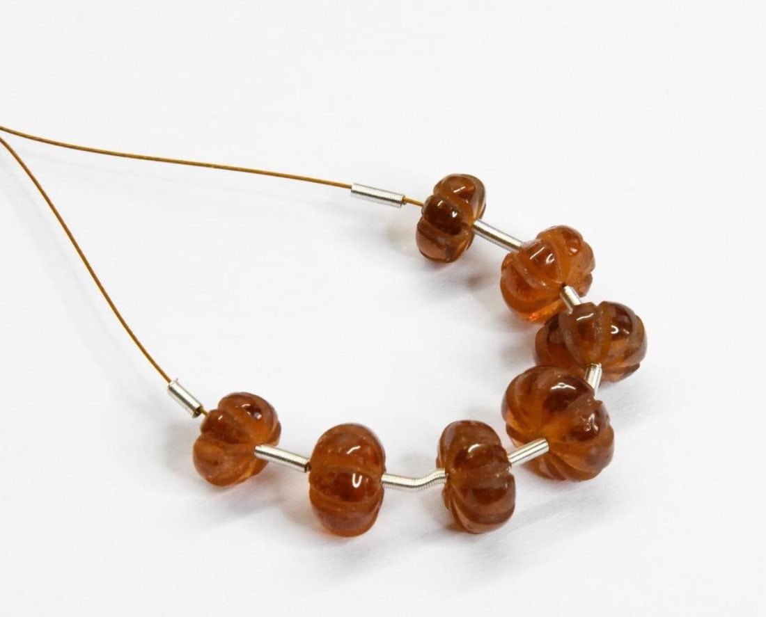 NATURAL HESSONITE GARNET BEADS CARVED RONDELLE 6.5 - 8.5 MM 7 PCS: These are natural, earth mined and hand crafted with precision. Stone: Hessonite Garnet, Stone Shape: Carved Rondelle, Stone Size: 6.5 - 8.5 mm, Width: 3.5 - 5 mm, Weight: approx. 19 carats. The photo