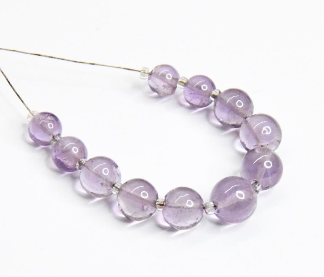 NATURAL AMETHYST BEADS ROUND 5 - 7 MM, 11 PCS: These are natural, earth mined and hand crafted with precision. Stone: Amethyst, Stone Shape: Round, Stone Size: 5 - 7 mm, Weight: approx. 18 carats. The photographs are generally enlarged to show the