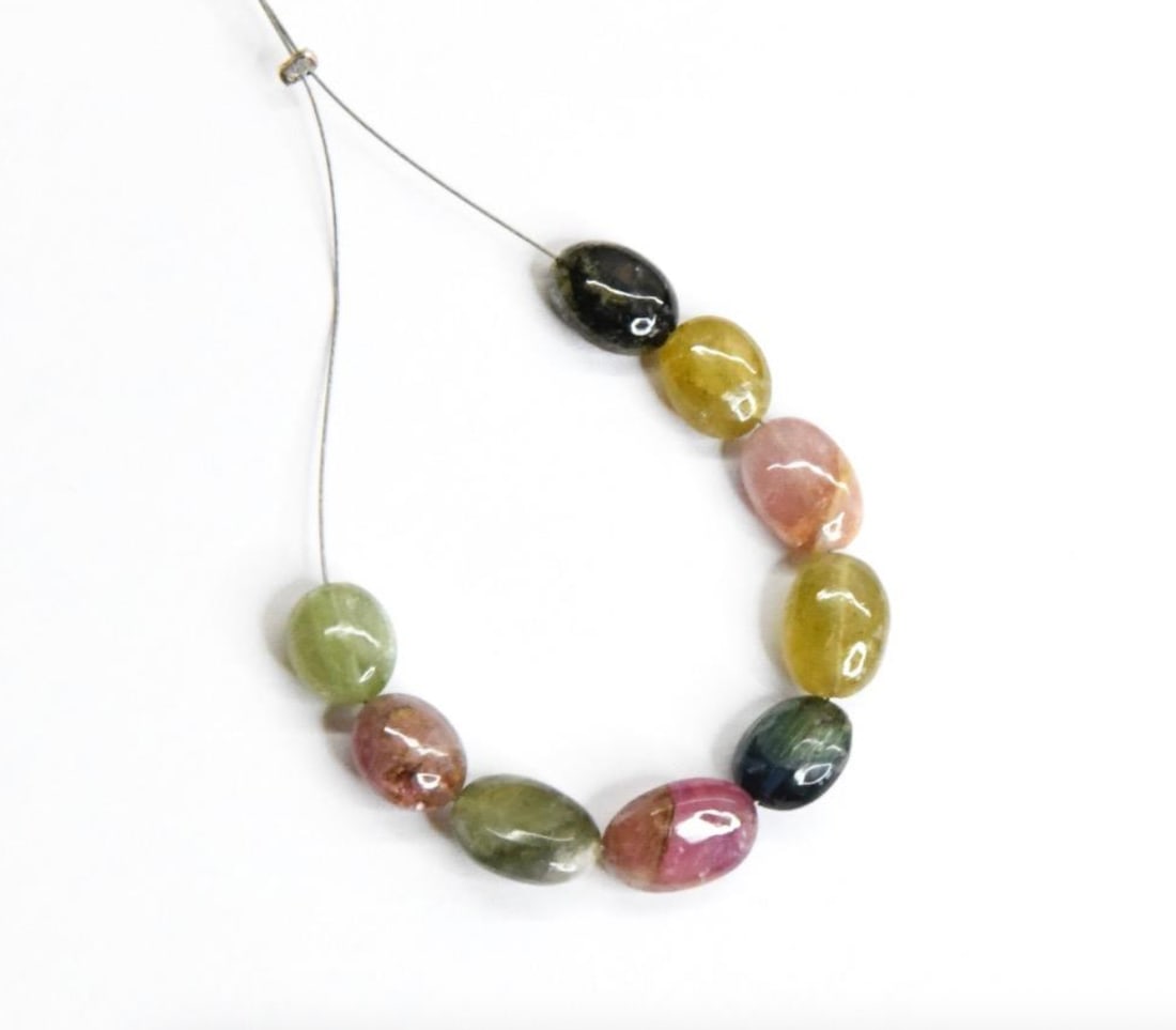 NATURAL MULTI TOURMALINE BEADS OVAL 6.5X8 - 7X10 MM, 9 PCS: These are natural, earth mined and hand crafted with precision. Stone: Multi Tourmaline, Stone Shape: Oval, Stone Size: 6.5x8 - 7x10 mm, Width: 4 - 4.5 mm, Weight: approx. 20 carats. The photographs a