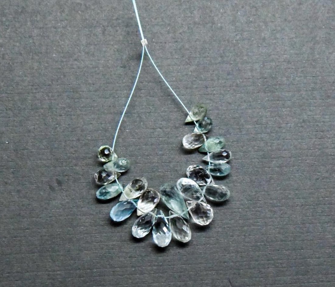 NATURAL AQUAMARINE BEADS FACETED BRIOLETTE 4X5.5 - 5X12 MM, 21 PCS: These are natural, earth mined and hand crafted with precision. Stone: Aquamarine, Stone Shape: Faceted Briolette, Stone Size: 4x5.5 - 5x12 mm, Weight: approx. 24 carats. The photographs are generally