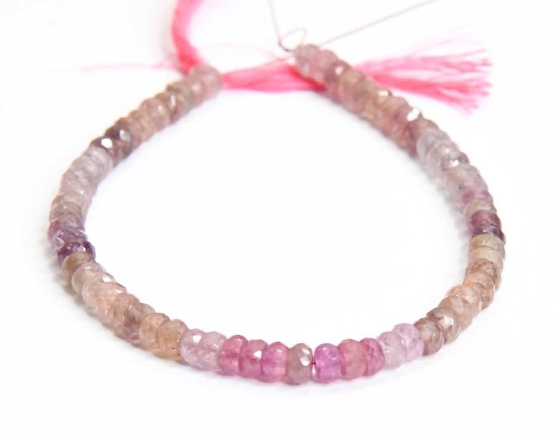 NATURAL PINK SAPPHIRE BEADS FACETED RONDELLE 4 - 4.5 MM, 6" STRAND: These are natural, earth mined and hand crafted with precision. Stone: Pink Sapphire, Stone Shape: Faceted Rondelle, Stone Size: 4 - 4.5 mm, Width: 2 - 2.5 mm, Weight: approx. 40 carats. The photograp