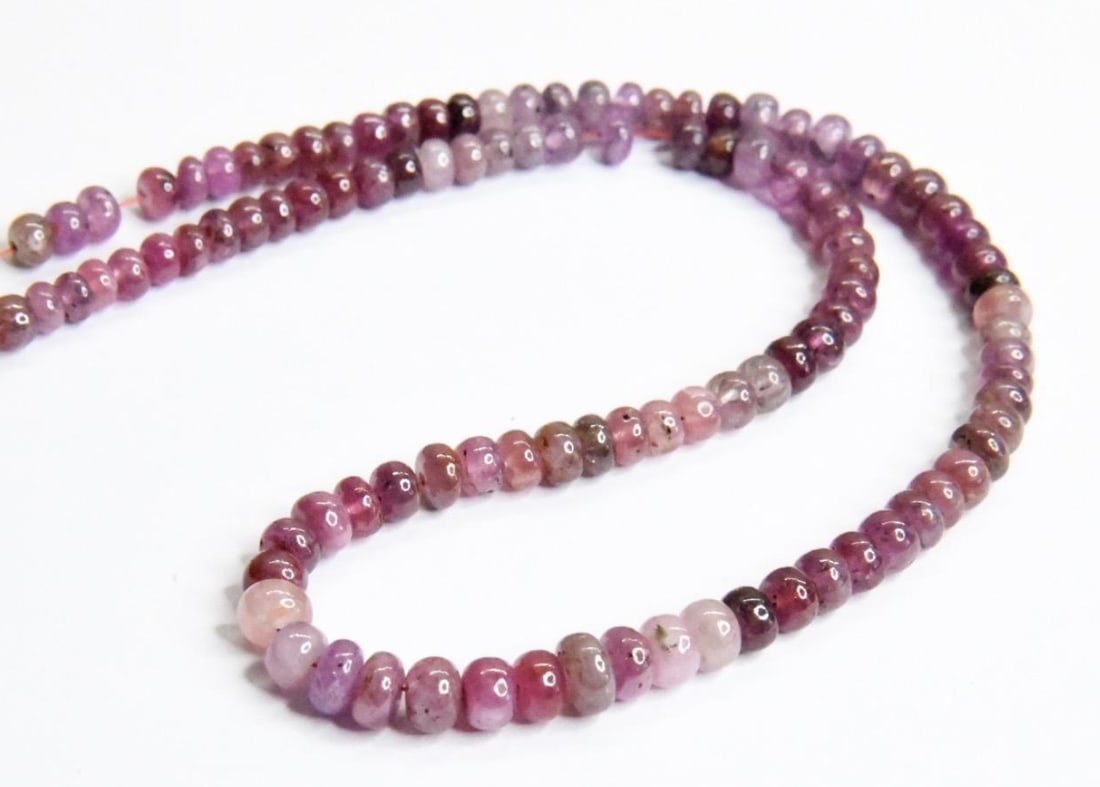 NATURAL PINK SAPPHIRE (SHADED) BEADS RONDELLE 3.5 - 5.5 MM, 14" STRAND: These are natural, earth mined and hand crafted with precision. Stone: Pink Sapphire (Shaded), Stone Shape: Rondelle, Stone Size: 3.5 - 5.5 mm, Width: 2 - 3.5 mm, Weight: approx. 93 carats. The photog