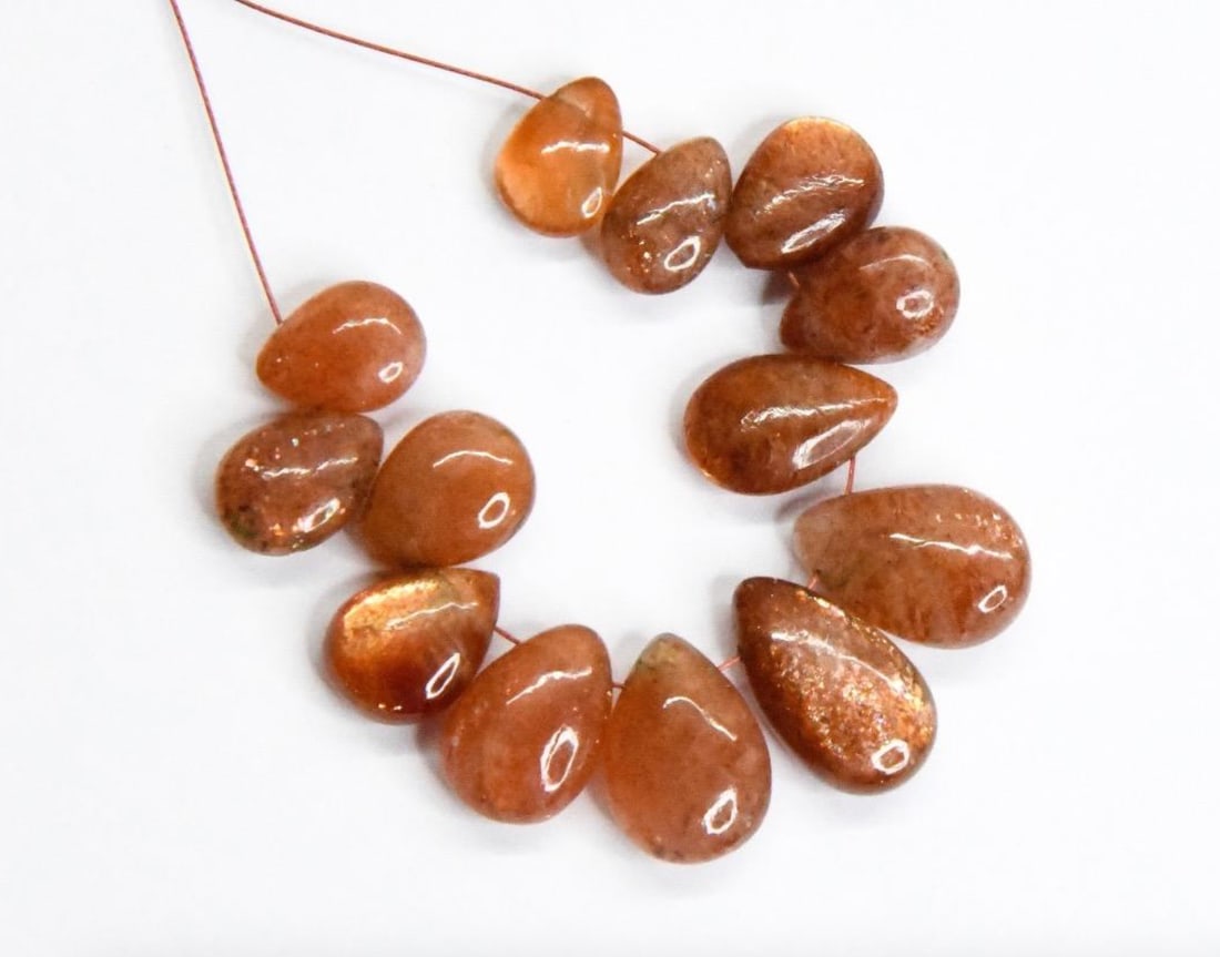 NATURAL SUNSTONE BEADS PEAR 6.5X9.5 - 9X13.5 MM, 13 PCS: These are natural, earth mined and hand crafted with precision. Stone: Sunstone, Stone Shape: Pear, Stone Size: 6.5x9.5 - 9x13.5 mm, Width: 3.5 - 5.5 mm, Weight: approx. 38 carats. The photographs are