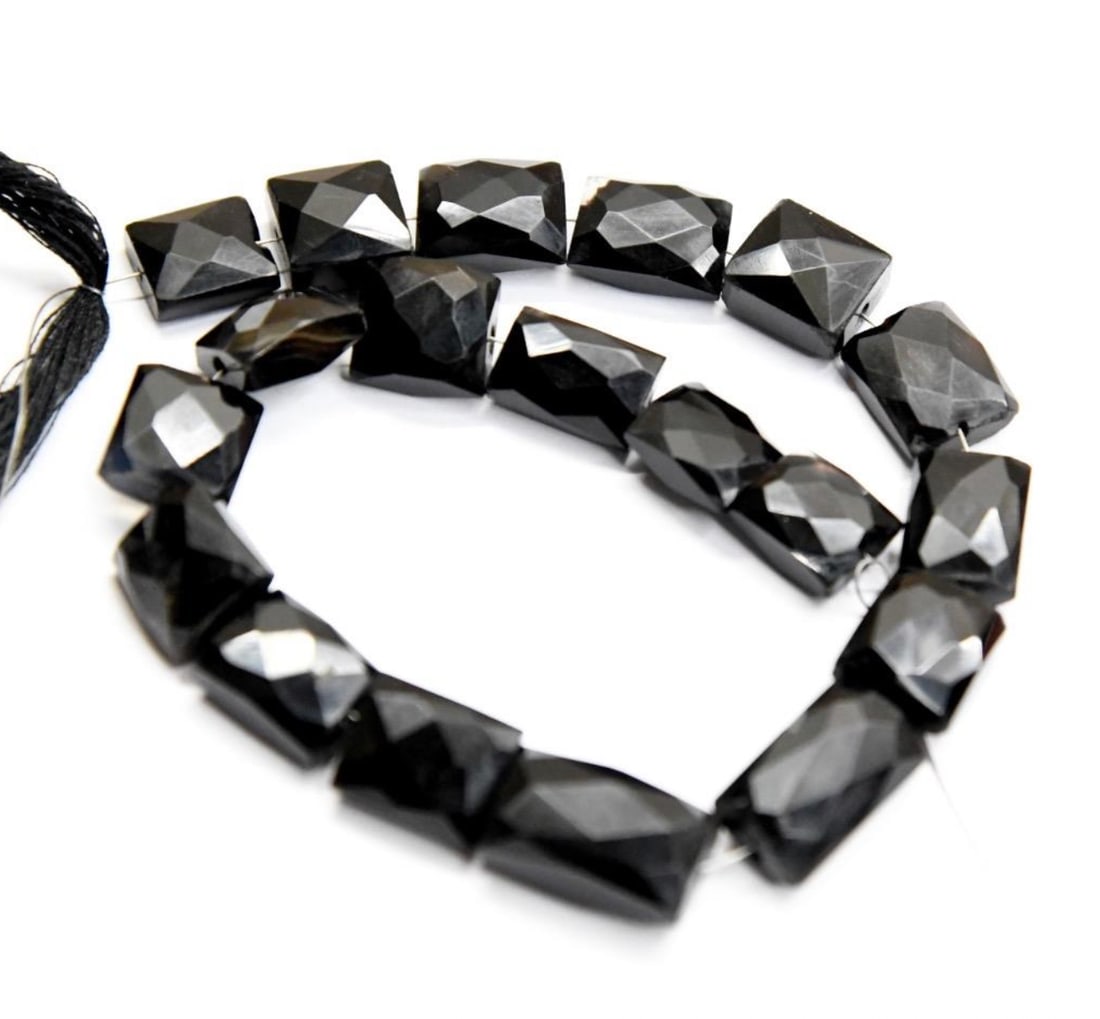 NATURAL BLACK CHALCEDONY BEADS FACETED CHICKLET 9X10 - 10X17 MM, 9" STRAND: These are natural, earth mined and hand crafted with precision. Stone: Grey Moonstone, Stone Shape: Faceted Cube, Stone Size: 5x9.5 - 6x11 mm, Weight: approx. 48 carats. The photographs are generally