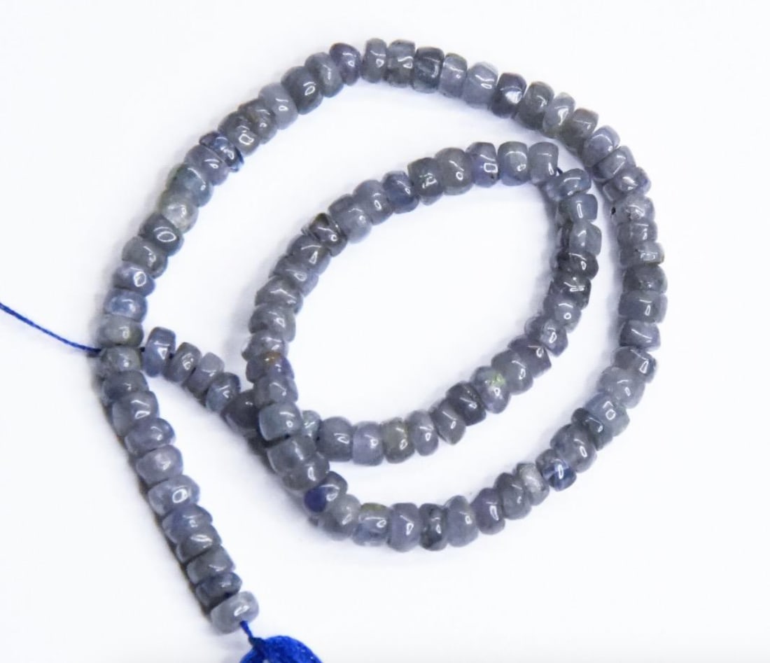 NATURAL TANZANITE BEADS RONDELLE 3.5 - 4 MM, 8.5" STRAND: These are natural, earth mined and hand crafted with precision. Stone: Tanzanite, Stone Shape: Rondelle, Stone Size: 3.5 - 4 mm, Width: 1.5 - 2.5 mm, Weight: approx. 34 carats. The photographs are gen