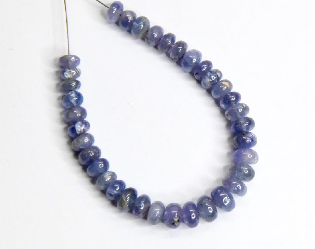 NATURAL TANZANITE BEADS RONDELLE 4.5 - 6 MM, 35 PCS: These are natural, earth mined and hand crafted with precision. Stone: Tanzanite, Stone Shape: Rondelle, Stone Size: 4.5 - 6 mm, Width: 2 - 4 mm, Weight: approx. 32 carats. The photographs are general