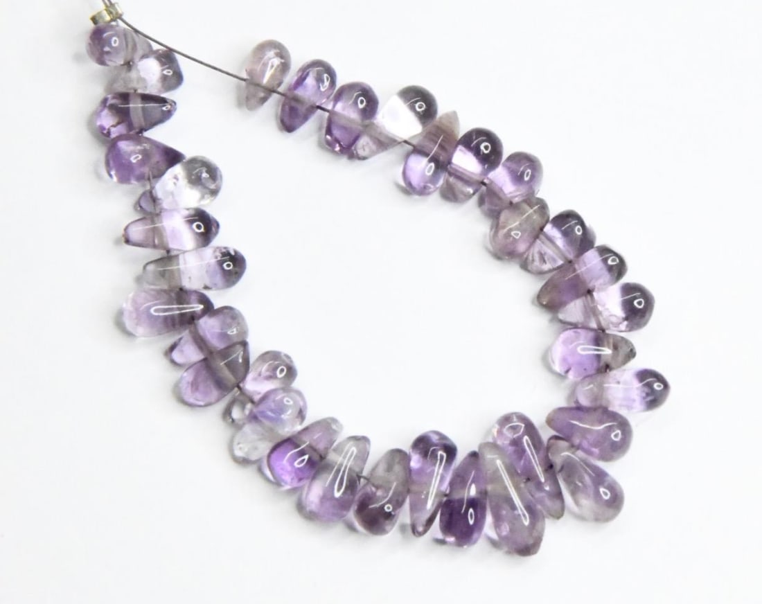 NATURAL AMETHYST BEADS BRIOLETTE 3X6 - 4X10 MM, 34 PCS: These are natural, earth mined and hand crafted with precision. Stone: Amethyst, Stone Shape: Briolette, Stone Size: 3.5x6 - 4x10 mm, Weight: approx. 30 carats. The photographs are generally enlarged