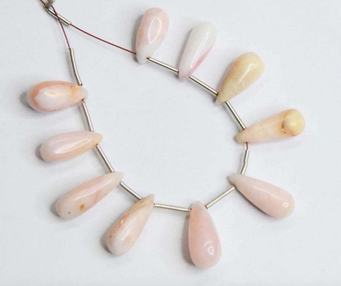 NATURAL PINK OPAL BEADS BRIOLETTE 5X13 - 6X15 MM, 10 PCS: These are natural, earth mined and hand crafted with precision. Stone: Pink Opal, Stone Shape: Briolette, Stone Size: 5x13 - 6x15 mm, Weight: approx. 25 carats. The photographs are generally enlarged