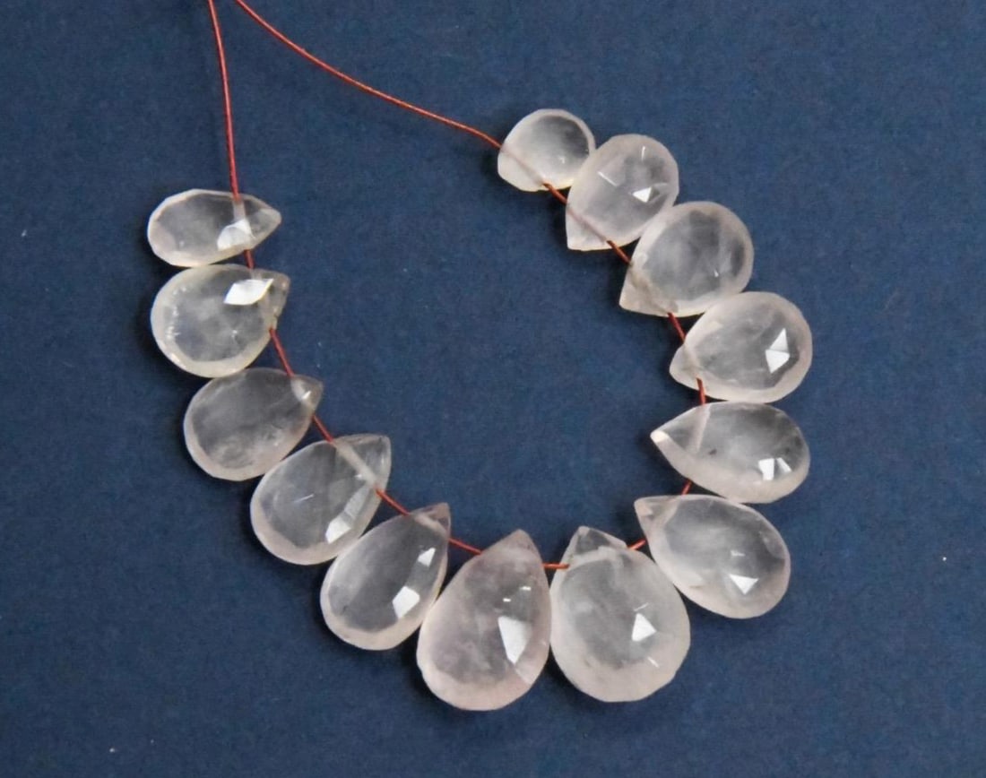 NATURAL ROSE QUARTZ BEADS FACETED PEAR 5X7 - 9X12 MM, 13 PCS: These are natural, earth mined and hand crafted with precision. Stone: Rose Quartz, Stone Shape: Faceted Pear, Stone Size: 5.5x7 - 9x12.5 mm, Width: 3 - 6 mm, Weight: approx. 28 carats. The photograph