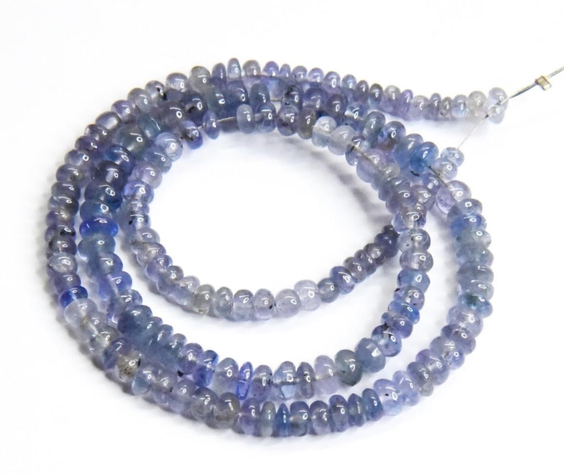 NATURAL TANZANITE BEADS RONDELLE 3 - 4.5 MM, 14" STRAND: These are natural, earth mined and hand crafted with precision. Stone: Tanzanite, Stone Shape: Rondelle, Stone Size: 3 - 4.5 mm, Width: 1.5 - 3 mm, Weight: approx. 64 carats. The photographs are gener