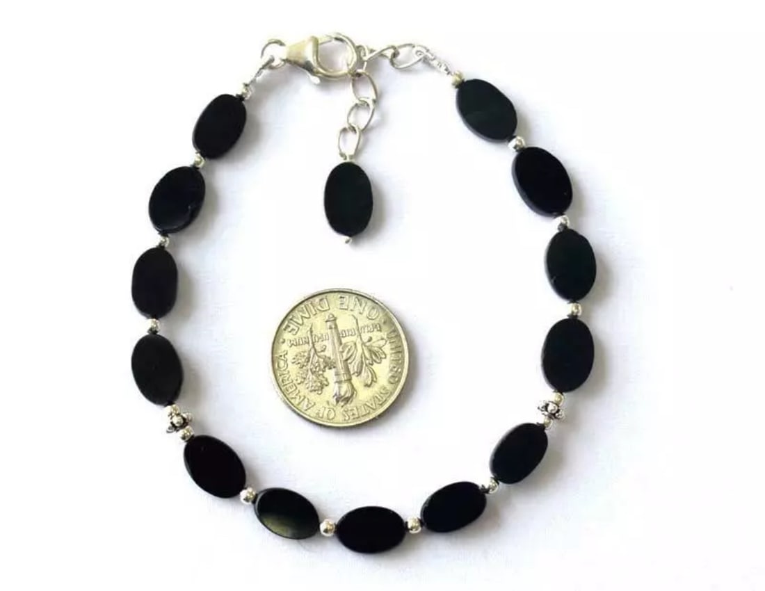 6.5 - 7.5" BRACELET NATURAL BLACK SPINEL BEADS OVAL SOLID 925 SILVER: These are natural, earth mined and hand crafted with precision. Stone: Spinel, Stone Shape: Oval, Stone Size: 5x8 - 6x9mm, Width - 2 - 3mm, Length: 6.5 - 7.5", Weight: approx. 34 carats. The photograp
