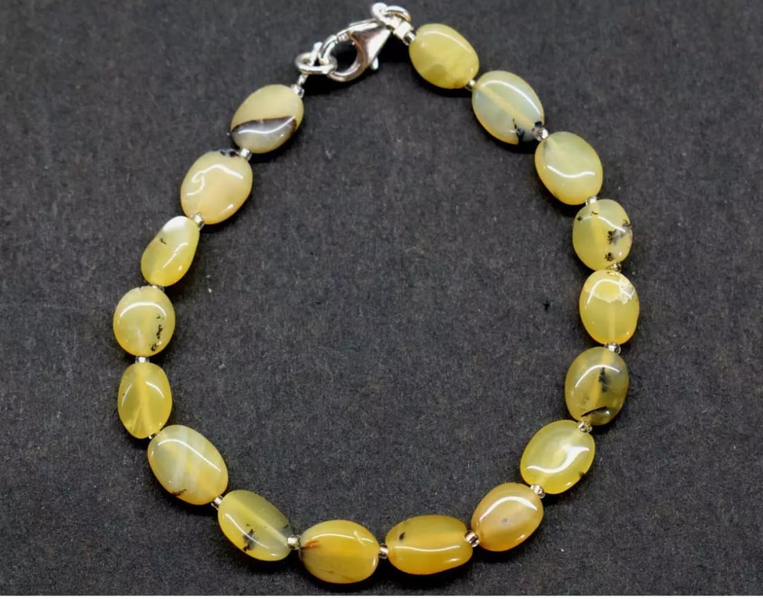 7.5" SOLID 925 SILVER BRACELET NATURAL YELLOW OPAL BEADS OVAL: These are natural, earth mined and hand crafted with precision. Stone: Yellow Opal, Shape: Oval, Size: 6.5x8 - 7x10 mm, Width - 2.5 - 3.5 mm, Length: 7.5", Weight: approx. 27 carats. The photographs a
