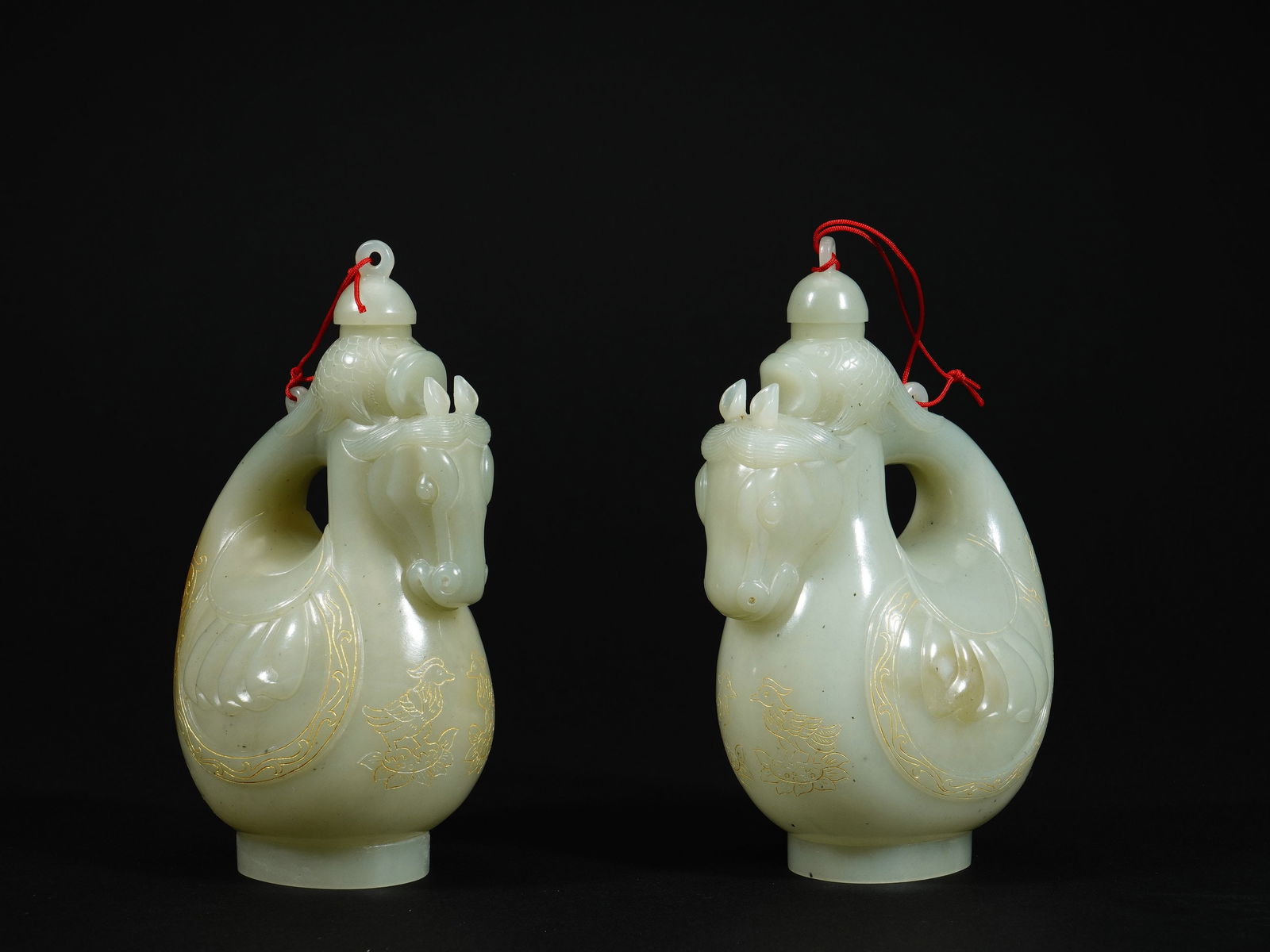 A pair of Hetian jade saddle flasks: Height 14.2cm Width 8.5cm