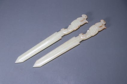 A pair of Hetian jade weapons with imperial inscriptions