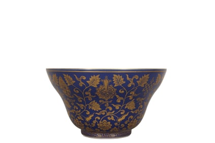 A blue-glazed bowl with gilded floral patterns