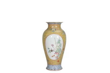 A famille rose brocade ground Guanyin vase with a window and floral ornaments