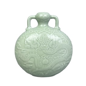 A moon-embracing vase with powder-green glaze and carved patterns of sea water, Ruyi, bats, clouds