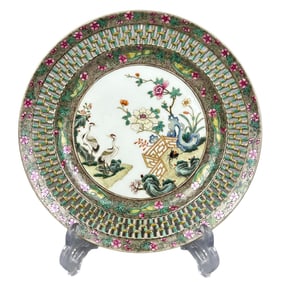 A plate with carved enamel floral and bird designs.