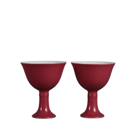 A pair of rouge-red underglaze famille rose high-footed cups with melon and fruit designs