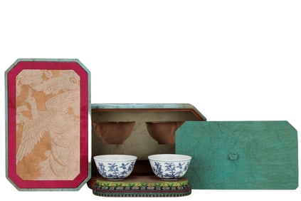 A pair of blue and white cups with flower and bird patterns