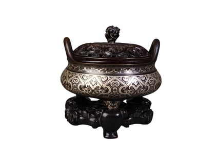 A copper-silver tripod incense burner with two handles