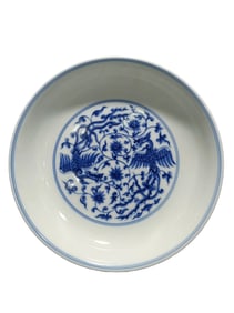 Blue and white porcelain plate with phoenix and intertwined branches design