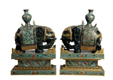 A pair of cloisonné and jade inlaid elephant ornaments symbolizing peace and prosperity.