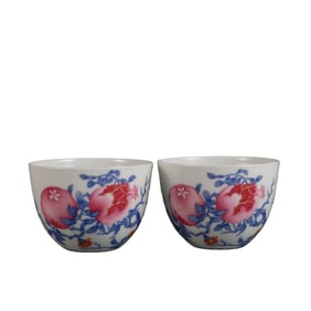 A pair of famille rose pomegranate-patterned jars and cups