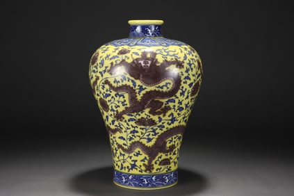 Blue and white porcelain vase with floral and dragon design on a yellow ground
