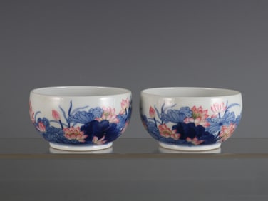 pair of blue and white porcelain cups with famille rose lotus patterns