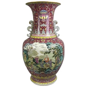A large, heavily decorated famille rose vase with a crimson ground and intertwined floral patterns,