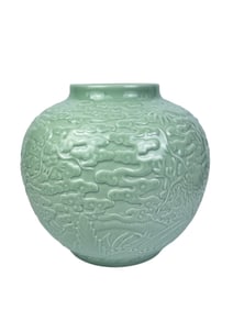 celadon-glazed jar with relief design of a dragon teaching its son amidst waves and clouds.