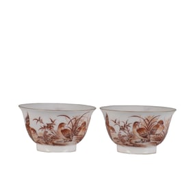 A pair of iron-red quail cups with hidden engraving of lotus scrolls inside.