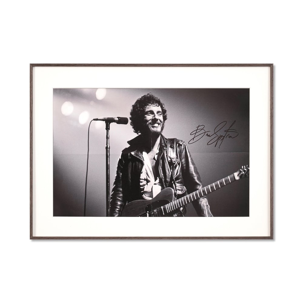 BRUCE SPRINGSTEEN SIGNED PHOTOGRAPH: Image Dimensions: 18 5/8 x 12 1/8 in (47.3 x 30.7 cm) Framed Dimensions: 16 1/2 x 23 1/8 in (42 x 58.7 cm) This signed photograph captures Bruce Springsteen in one of his most iconic states: