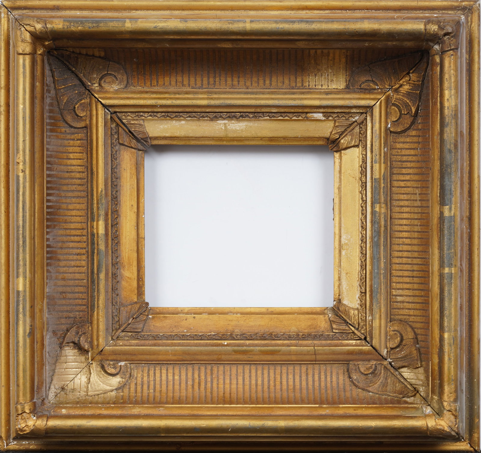Wide Gold Fluted Cove Giltwood Oil Painting Frame: Antique American oil painting frame. Measurements are listed verso as overall, rabbet and sight size, 13 by 14, 5.25 by 6, and 4.5 by 5 respectively. Please see all images for condition. For detailed