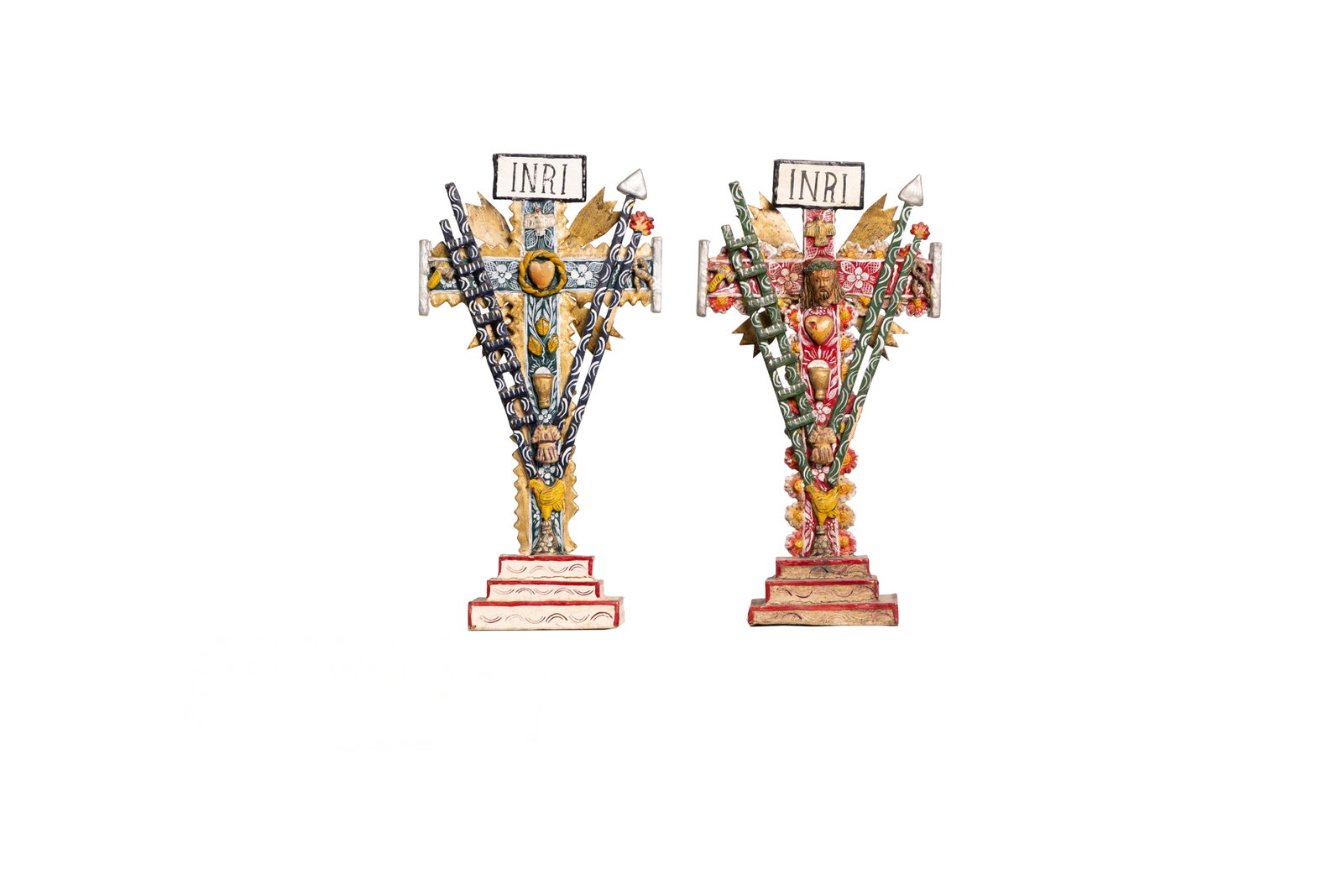 Pair of Painted INRI Folk Crosses with Symbolic Motifs: Two colorful folk-art INRI crosses decorated with symbolic tools and religious motifs. Each approx. 10.25" tall and 5.25" wide.Please see all images for condition. Size is measured and written on the 