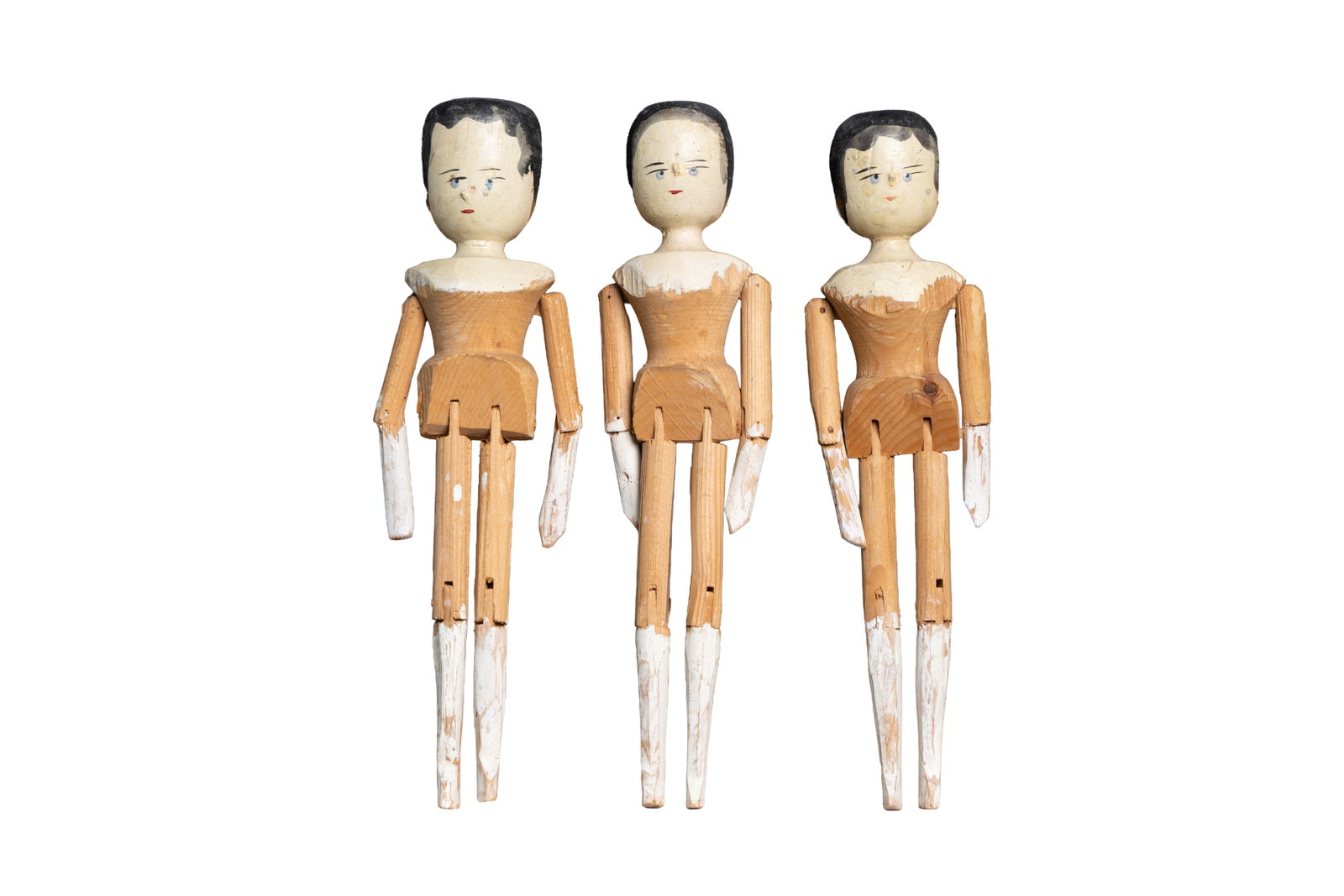 Set of Three Jointed Wooden Dolls: Group of three painted jointed wooden dolls with articulated limbs. Each approx. 11.5" tall and 3" wide.Size is measured and written on the back of the painting or next to each object. The first size 