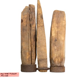 Three Primitive Wooden Fence Post Sculptures with Iron Bases