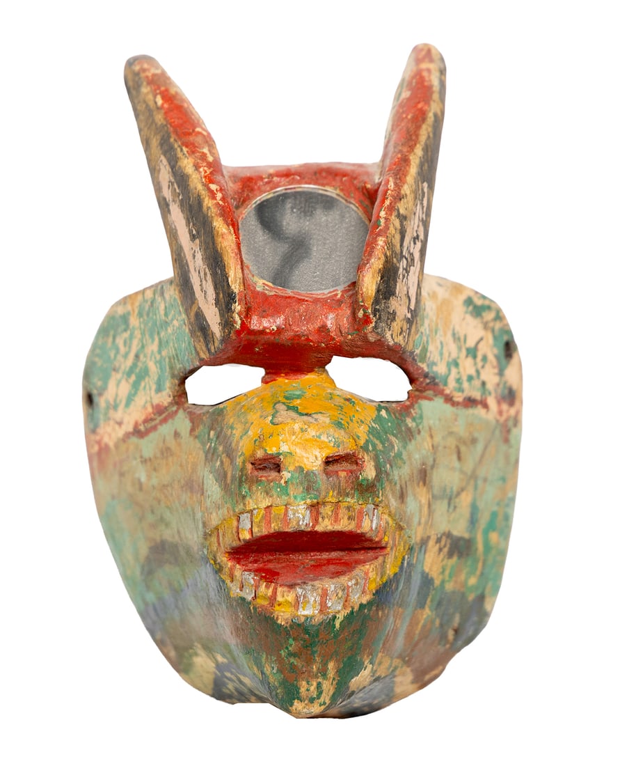Small Multicolor Horned Mask: Carved wooden mask with tall horns, multicolored paint, and carved teeth. Heavy surface wear throughout. Measuring: 9" x 5" wide x 6" deep. Size is measured and written on the back of the painting or