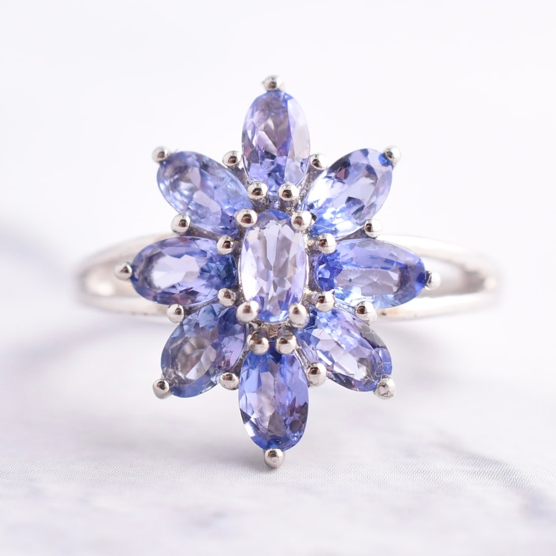 Natural Tanzanite Sterling Silver Burst Ring: Sterling Silver | Approximate Weight: 3.0g | Tanzanite | Size 6 1/4 | Piece is marked "925". Domestic flat rate shipping with Fedex is set to $45 plus insurance for this lot. Metals and stones are