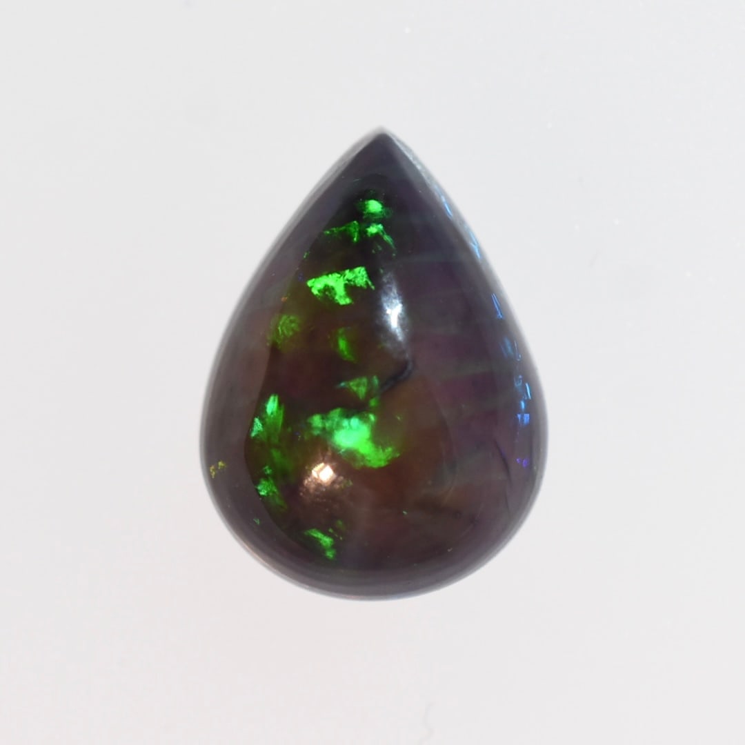 2.5ct Natural Black Opal Pear Cabochon: Size: 9 x 12mm Domestic flat rate shipping with Fedex is set to $45 plus insurance for this lot. Metals and stones are guaranteed. Please see all images for condition For detailed condition questions 