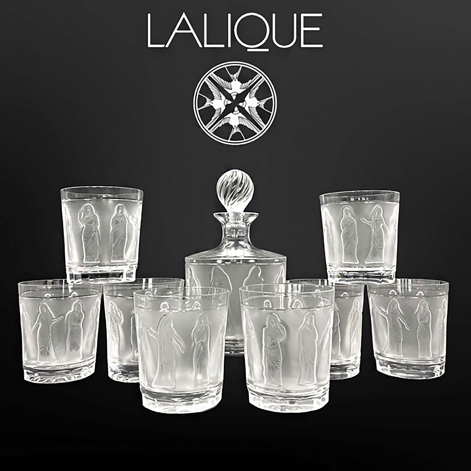 A Lalique Femme A L'Antique Crystal Liquor Service Set, Signed: A French Lalique Femme A L'Antique Crystal Liquor Service Set, Signed. Decanter: H 9.75" (24.5 cm) x D 5" (12.8 cm); tumblers: H 4 (10.00 cm) x D 3" (8.8 cm)