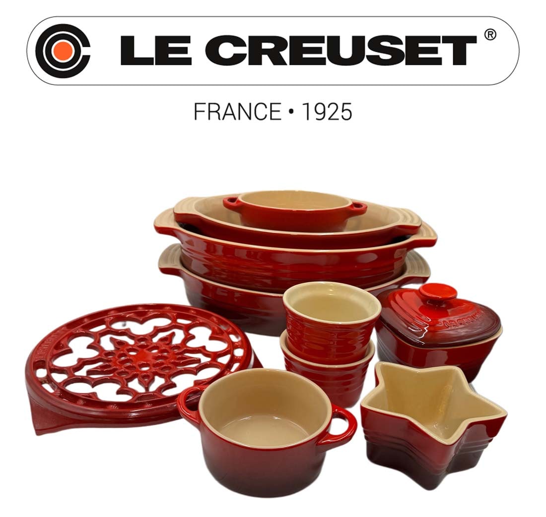 A Set of 10 French Le Creuset Red Gradient Cooking Stoneware: A Set of 10 French Le Creuset Stoneware in a red gradient finish, featuring various baking dishes, ramekins, and a heart-shaped casserole dish. Biggest size: 12" x 3" x 5"