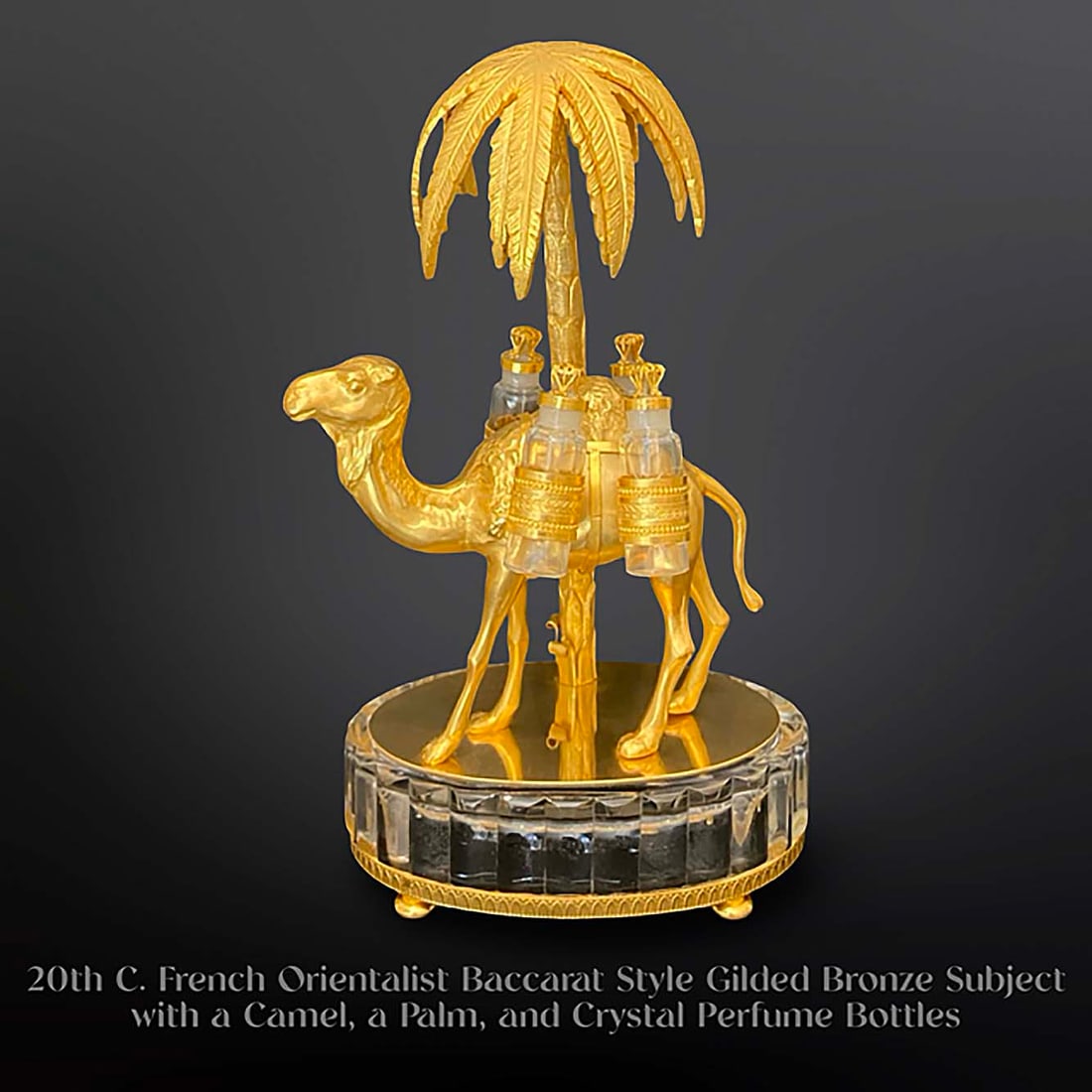 An Early 20th C. French Orientalist Figurine Group Gilt Bronze & Crystal Perfume Bottles: 20th C. French Orientalist Baccarat Style Gilt Bronze Subject with a Camel, a Palm, and Crystal Perfume Bottles. H 13" x L 7.5" x W 5.25"