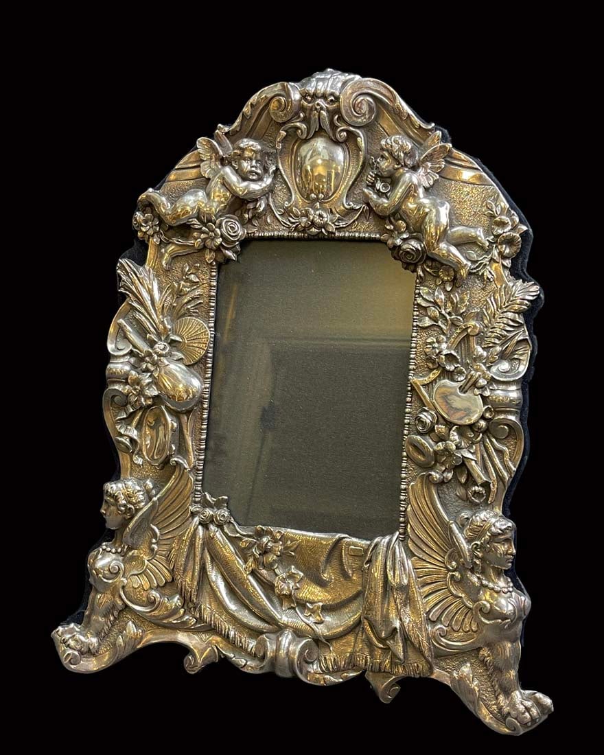 A Sterling Silver 925 Figural Frame: A Sterling Silver 925 Figural Frame. Frame: H 14" x 9.5", Canvas: 4.25" x 6"