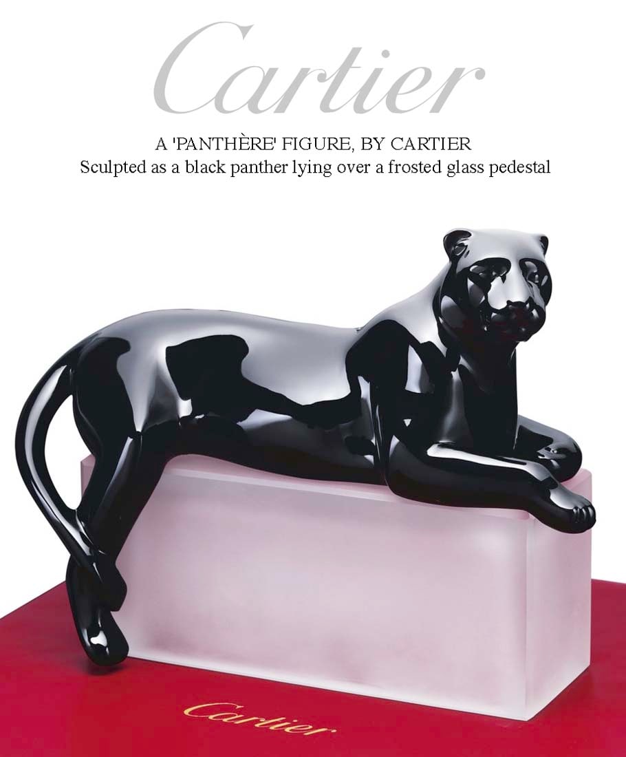 A CARTIER PANTHERE NOIRE FIGURINE ON FROSTED CRYSTAL BASE IN BOX: A FRENCH CARTIER PANTHERE NOIRE FIGURINE ON FROSTED CRYSTAL BASE, Sculpted as a black panther lying over a frosted glass pedestal in red leather Cartier case, Signed Cartier, Numbered: 009, Size: 34.0