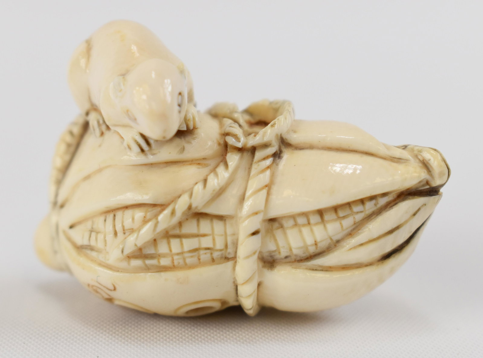 Carved Ivory Commercial Netsuke: Japanese, 20th Century A rat on a corn cob. Average height: 1 3/4"