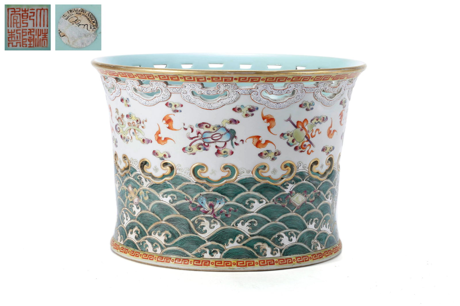 A Famille Rose Eight Treasures Brush Pot: A Famille Rose Eight Treasures Brush Pot 10 in. (25.5 cm.) diam. Qianlong Six-Character Mark. Provenance: Formerly in the collection of British Antique Dealer Association.