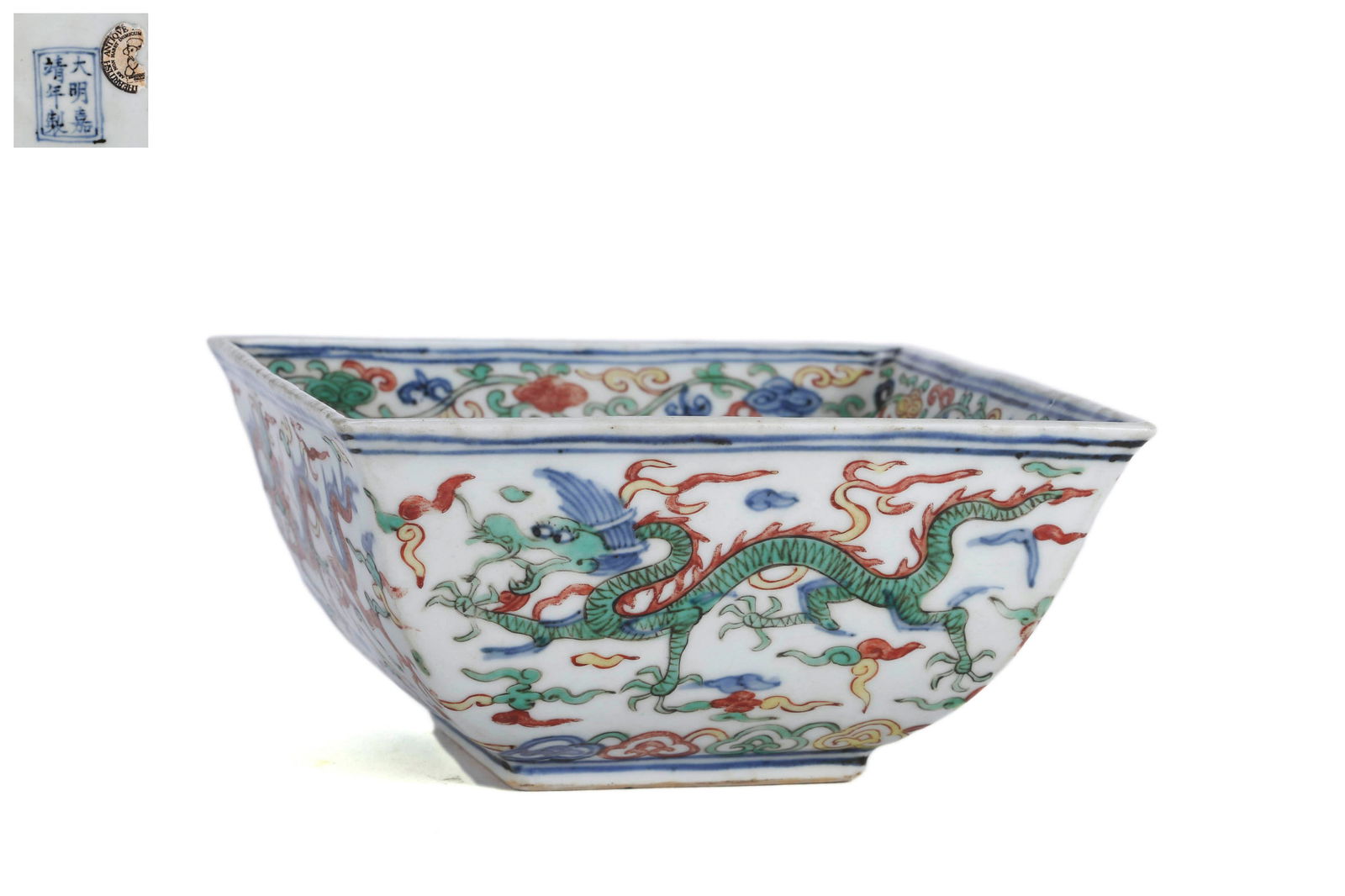 A Wucai Glaze Dragon Square Bowl: A Wucai Glaze Dragon Square Bowl 6 1/8 in. (15.5 cm.) wide Jiajing Six-Character Mark. Provenance: Formerly in the collection of British Antique Dealer Association.