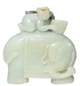 A JADE CARVING OF A BOY PLAYING WITH AN ELEPHANT